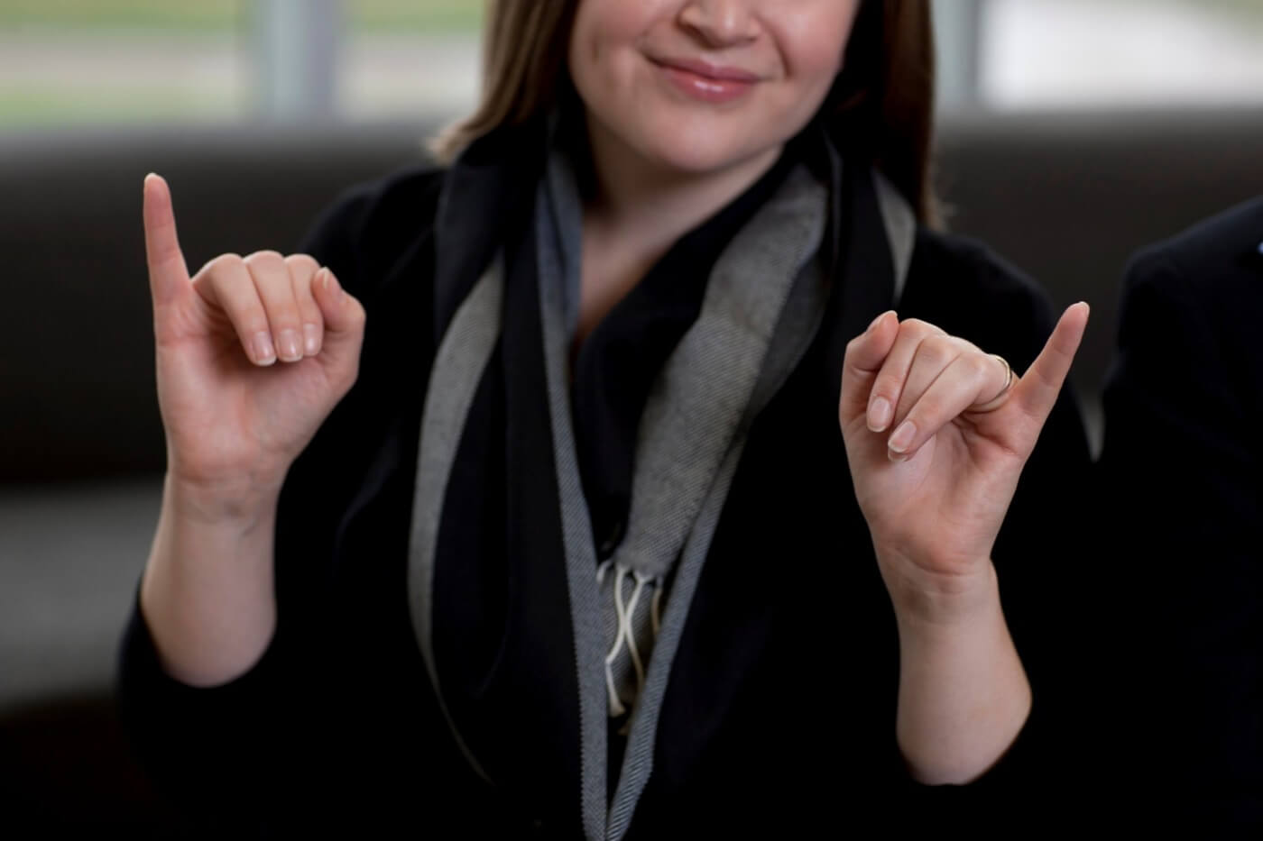 A person signs "independence" (two I hand shapes held at about shoulder level).