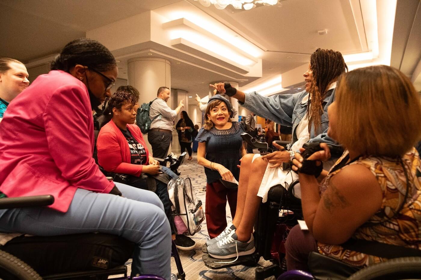 A group of advocates talk during NCIL's annual conference.