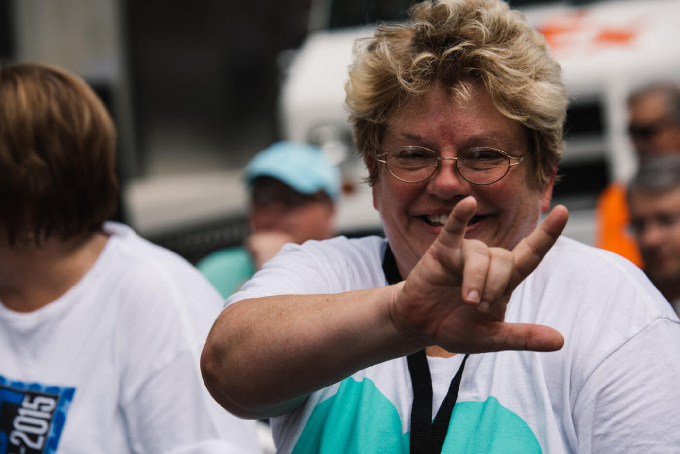 An advocate signs "I love you" at the camera.