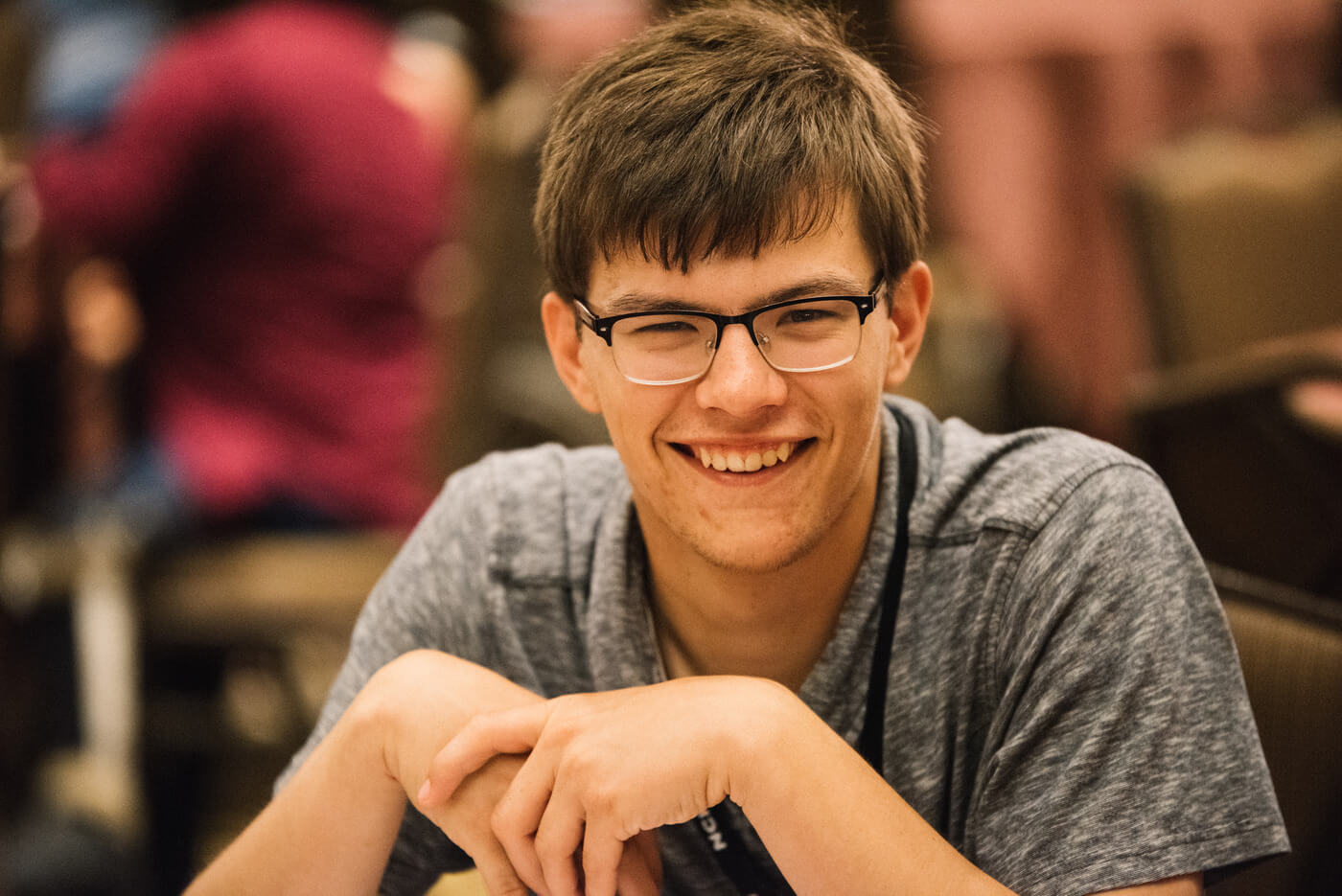 Luke Byram, a young white man with glasses and short brown hair, smiles at the camera.