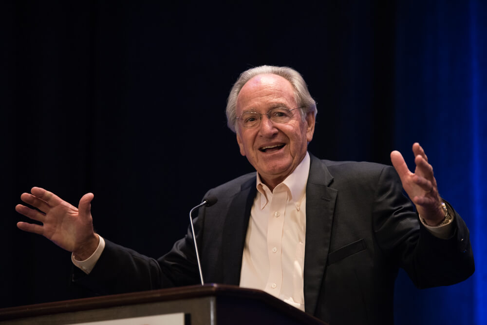 Senator Tom Harkin stands at a podium and gestures excitedly.