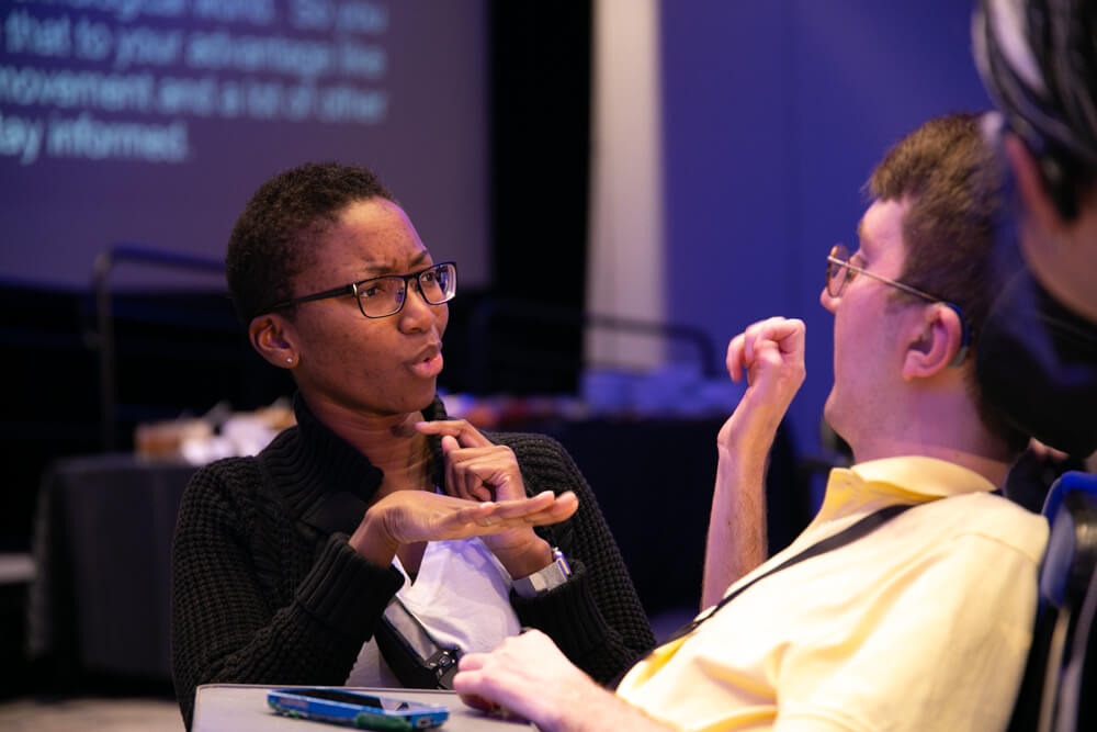 A Deaf advocate signs with an interpreter at NCIL's annual conference.