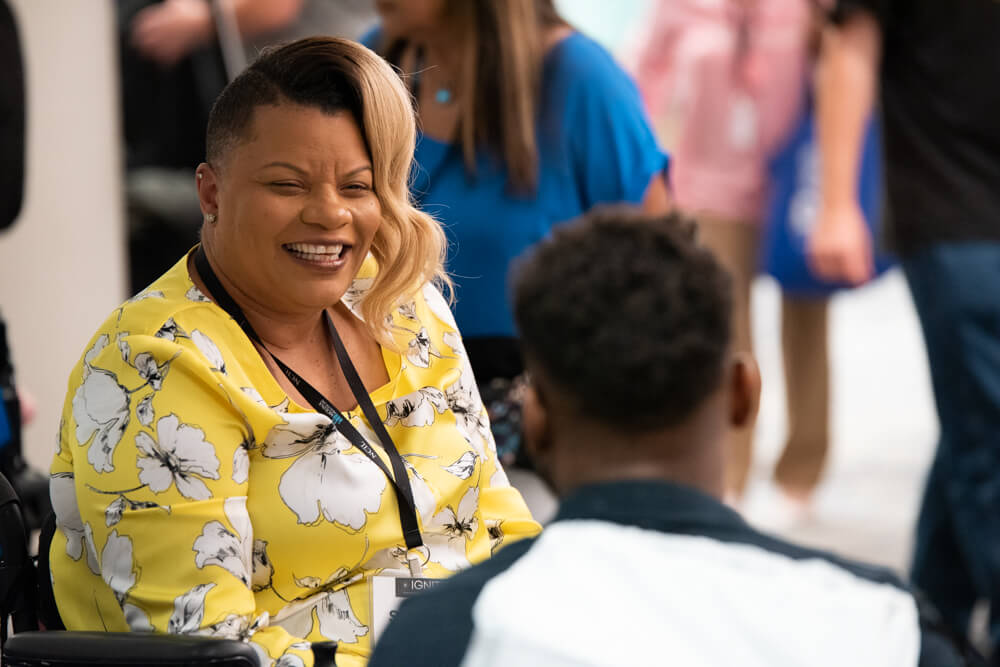 Shannon Minnick smiles in conversation with another advocate.