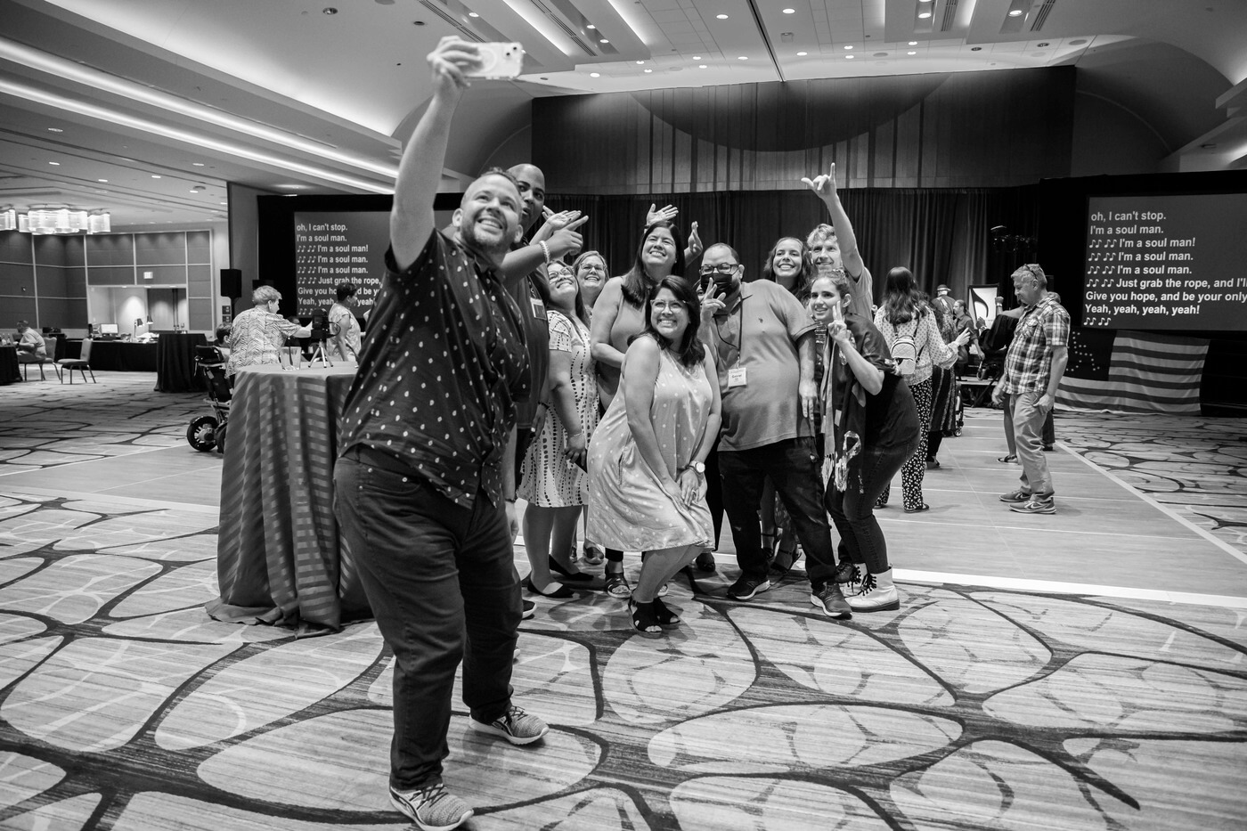 A black and white photo of a group of advocates taking a selfie.
