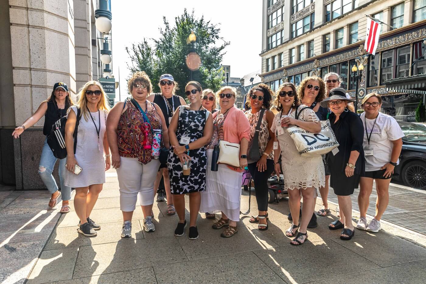 A diverse group of advocates stands in the middle of a DC sidewalk.