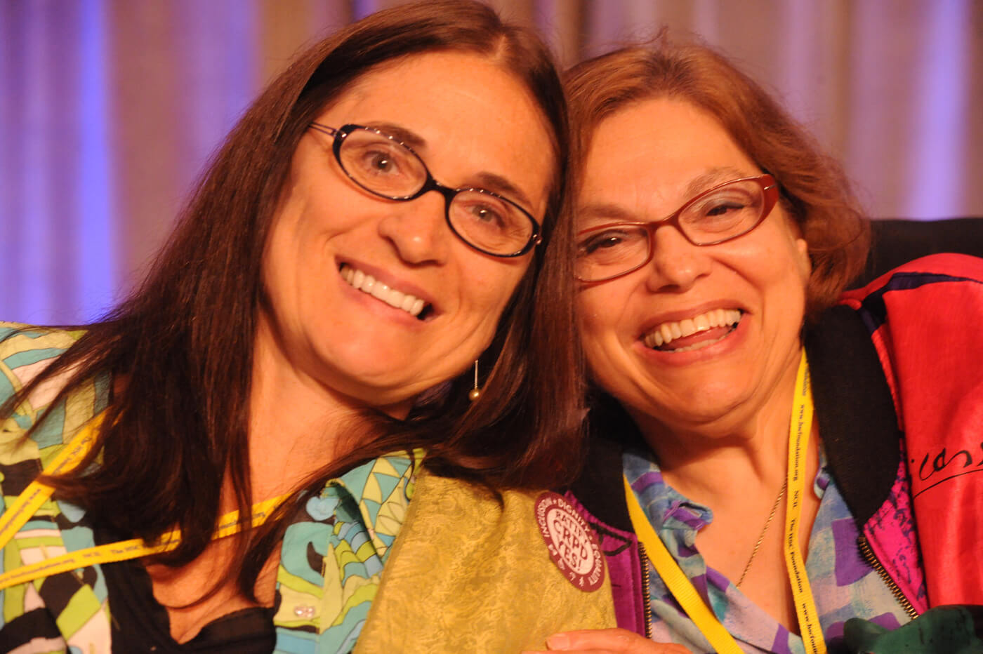 Close up photo of Marca Bristo and Judy Heumann together.