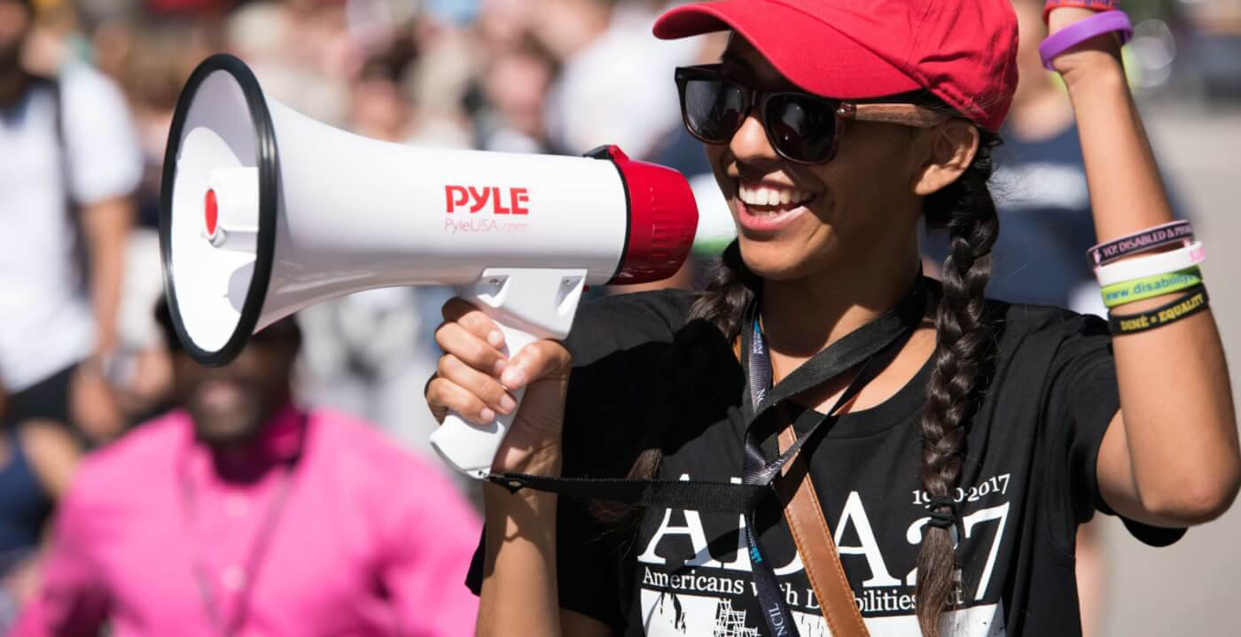 Jessica Jimenez shouts into a bullhorn at NCIL's annual March and Rally.