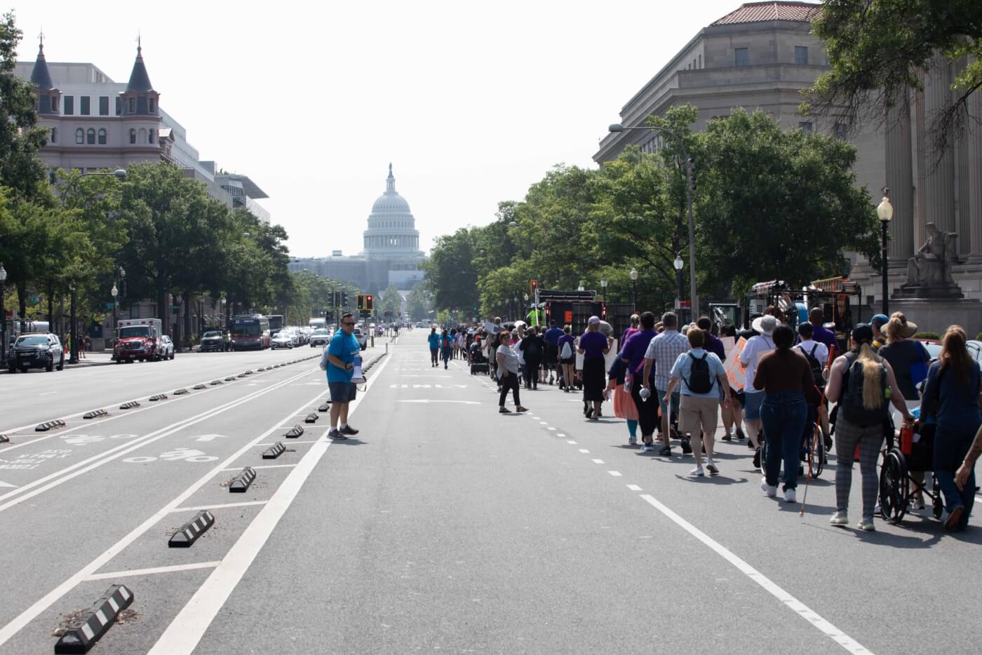 Hundreds of NCIL advocates march through the streets of DC toward the U.S. Capitol.