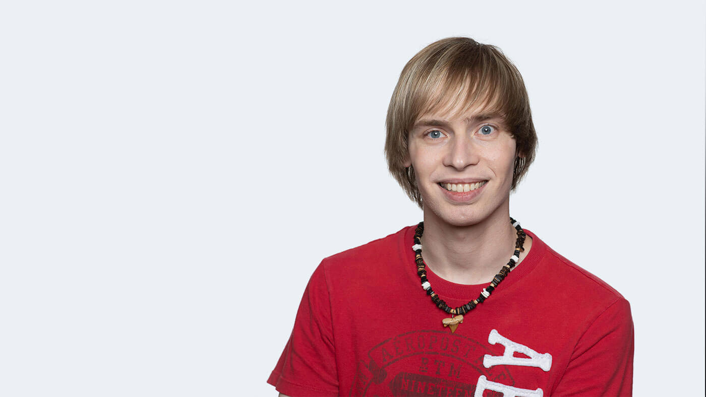 Daniel Soya, a young white person with short blonde hair, smiles at the camera.