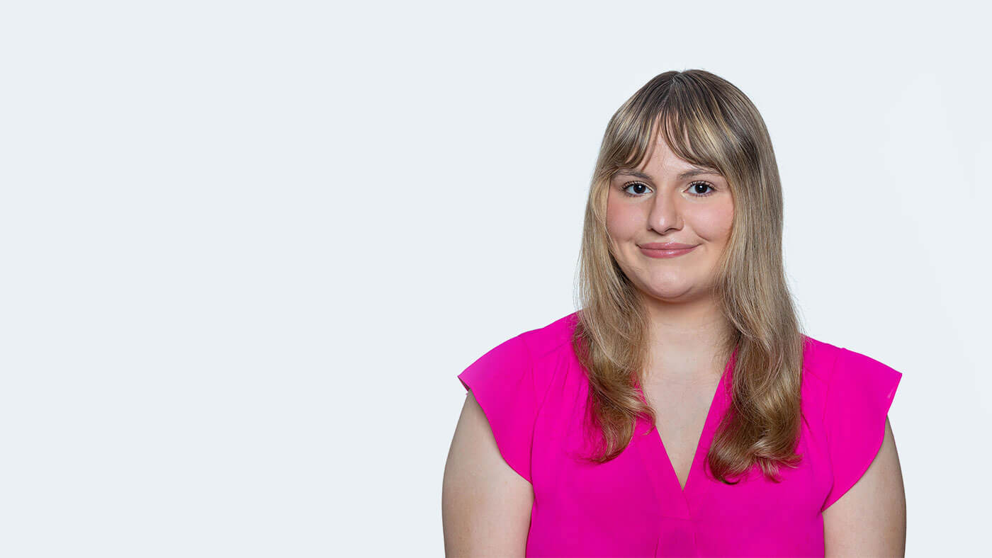 Elizabeth Walters, a young white woman with medium length blonde hair, smiles at the camera.
