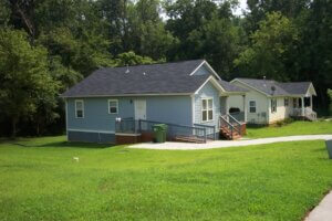 Example of a house with a steep down-hill at the rear - access is provided by concrete walkway leading to front entrance