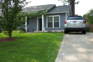 Example of a visitable home built on a hill - access provided by a concrete walkway from driveway to a zero step front entrance