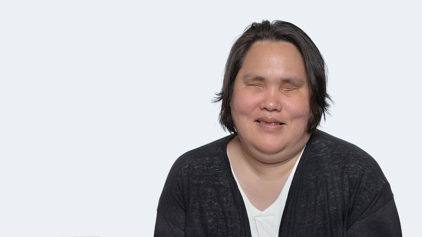 Keao Wright, a blind person with short black hair, faces the camera with eyes closed.