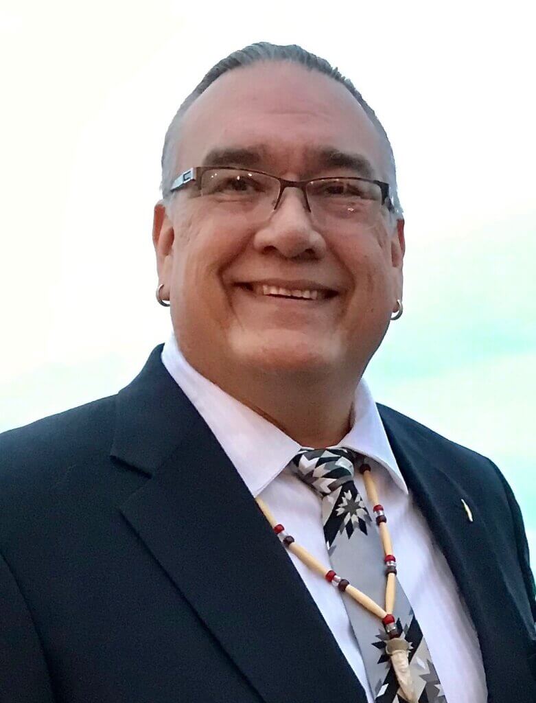 Native American Big and Tall Man with long greying hair.