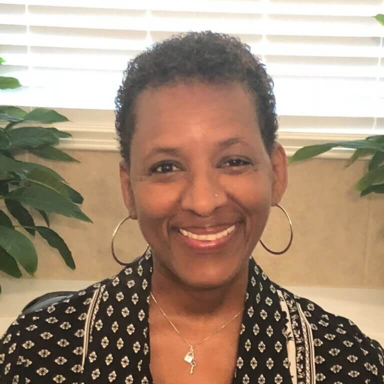 Headshot of Shelly Simmons smiling brightly in an office setting.