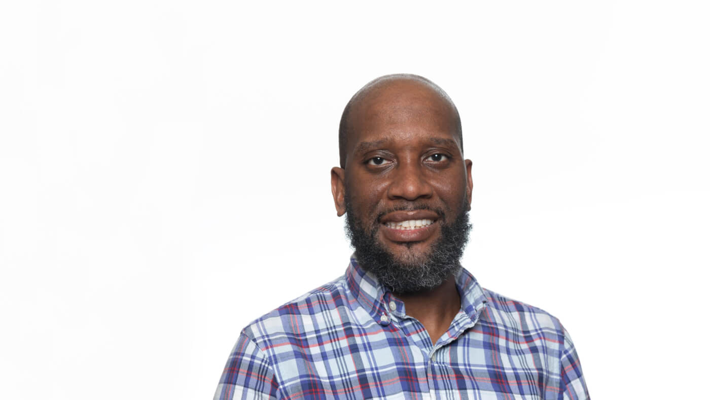 Headshot of Kelvin Hawkins from the 2025 Conference Headshot session. Each photo shows the NCIL member from the chest up, on a stark white background.