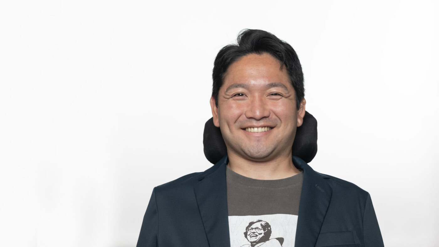 Headshot of Kyota Yagi from the 2025 Conference Headshot session. Each photo shows the NCIL member from the chest up, on a stark white background.