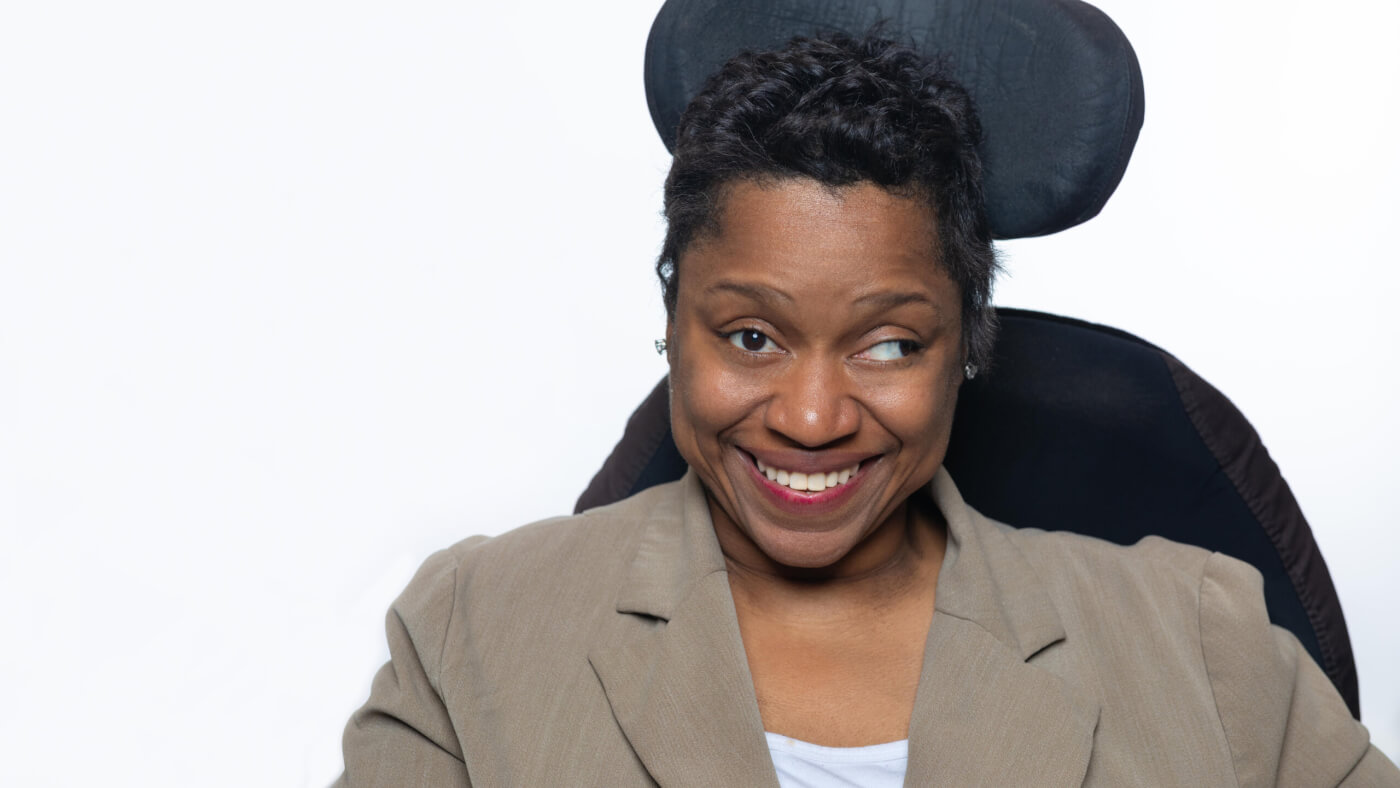 Headshot of Rochelle Harrod from the 2025 Conference Headshot session. Each photo shows the NCIL member from the chest up, on a stark white background.