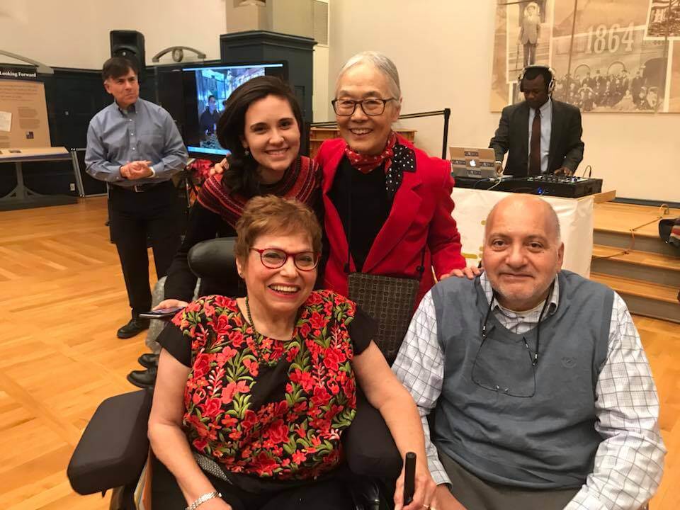 Jorge Pineda, Judy Heumann, Sara Pineda, and Yoshiko Dart gather together for a group photo during Judy’s 70th birthday celebration at Gallaudet University in 2017. Photo credit: Rie Terashima.
